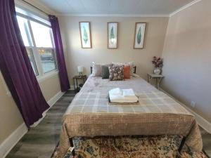 a bedroom with a large bed and a window at Stay St Paul Haven in West Saint Paul