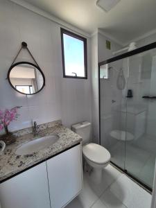 a bathroom with a toilet and a sink and a shower at Beira Mar Apartment Aracaju in Aracaju +12 photos