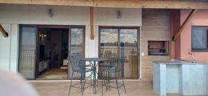 a patio with chairs and a table in front of a house at Edificio El Príncipe - Encarnación in Encarnación