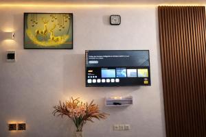 a flat screen tv hanging on a wall at Les studios meublés d'Angré in Abidjan