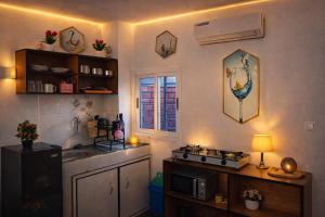 a kitchen with a stove and a sink in it at Les studios meublés d'Angré in Abidjan