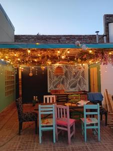 a patio with a table and chairs and lights at casa azul in Plottier