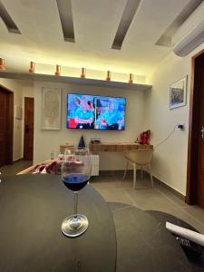 a glass of wine sitting on a table in a living room at Chaleville barrinha in Barrinha