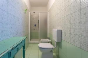a bathroom with a white toilet and a shower at B&B Cascina Baraggione in Granozzo con Monticello +45 photos