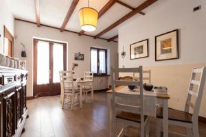 a kitchen and dining room with a table and chairs at B&B Cascina Baraggione in Granozzo con Monticello
