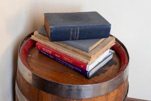 a stack of books sitting on top of a barrel at B&B Cascina Baraggione in Granozzo con Monticello