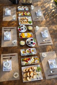 a table with plates of food and cups of coffee at Poe Guesthouse in Avatoru