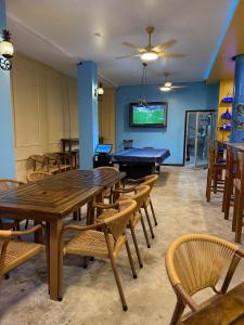 a dining room with a ping pong table and chairs at Hotel Royal Blue & Golf Cart Rental in San Pedro
