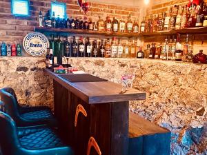 a bar with two chairs and bottles of alcohol at Cabanas Madre Tierra Zacatlan in Cedro +67 photos