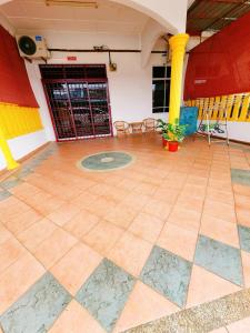 a room with a tiled floor in a building at Mersing 746homestay-9pax in Mersing