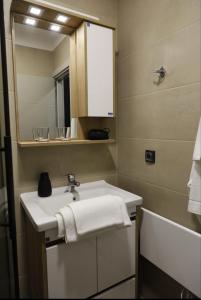 a bathroom with a sink and a mirror and a tub at Apart-Hotel Bela Reka in Brzeće +36 photos