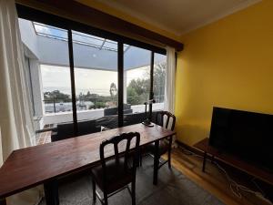 a dining room with a table and a large window at Machico View in Machico