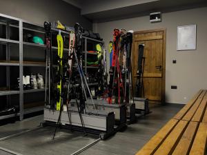a bunch of skis on display in a room at Apart-Hotel Bela Reka in Brzeće