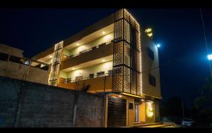 a large building with lights on it at night at Golden Appart in Godomey