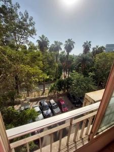 a balcony with cars parked in a parking lot at Cozy Queen bed room in zamalek with garden view and balcony in Cairo