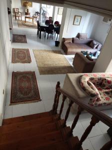 a view of a living room with rugs on the floor at Cozy Queen bed room in zamalek with garden view and balcony in Cairo