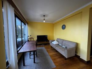a living room with a couch and a table at Machico View in Machico +40 photos