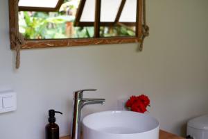 a bathroom sink with a mirror on a counter at Fare Malou in Vaïare