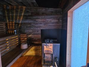 a room with a woodburning stove in a cabin at The Lakeview Cabin in Kiruna