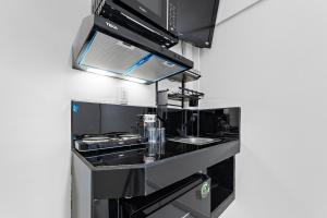 a kitchen with a stove and a sink at Suites Calle Berlin in Mexico City