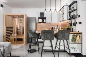 a kitchen with two bar stools and a counter at NOVA SPA - Sauna Suite for Two in Rijeka