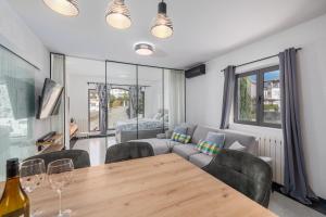 a living room with a table and chairs and a couch at NOVA SPA - Sauna Suite for Two in Rijeka