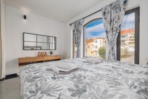 a bedroom with a large bed with a large window at NOVA SPA - Sauna Suite for Two in Rijeka