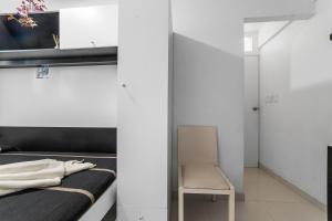 a bedroom with a bed and a chair in a room at Suites Calle Berlin in Mexico City