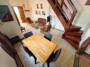 a dining room with a wooden table and chairs at Maytenus Galapagos in Puerto Ayora