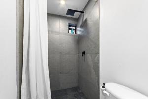 a bathroom with a shower with a white shower curtain at Suites Calle Berlin in Mexico City +11 photos