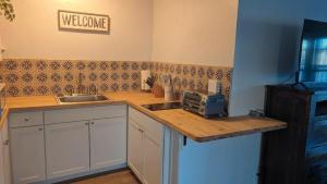 a kitchen with a counter top with a microwave at Studio Speedway in Tucson +4 photos