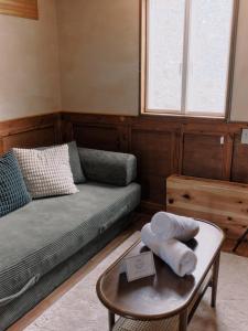 a living room with a couch and a table at Casa Bianca in Hakuba