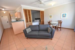 a living room with a couch and a table at Royal Palm Villas in Cairns