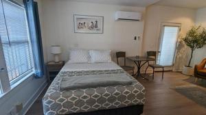 a bedroom with a bed and a table with chairs at Studio Speedway in Tucson
