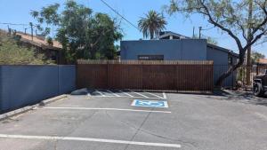 a parking lot with a fence and a car parked at Studio Speedway in Tucson