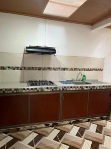 a kitchen with a sink and a stove at Aparta hotel Betania in Quimbaya +3 photos