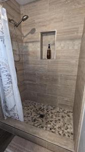 a shower with a tile floor and a shower stall at Studio Speedway in Tucson