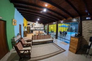 a living room with a couch and a dining room at Villa Kanindé Bonito in Bonito
