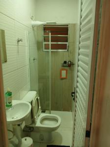a small bathroom with a toilet and a sink at Kitnet 4 Vila Lunardi in Campinas