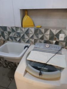 a bathroom with a toilet and a sink at Kitnet 4 Vila Lunardi in Campinas +4 photos
