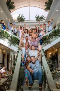 a group of people posing for a picture on a staircase at Hotel PATIO ZARAGOZA, Centro Histórico SLP in San Luis Potosí