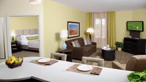 a hotel room with a dining table and a living room at Candlewood Suites Harlingen by IHG in Harlingen