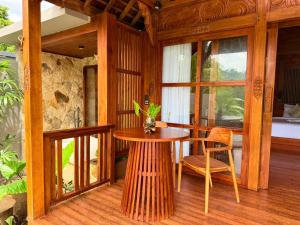a wooden room with a table and a chair at Wanataru Sidemen Villas in Sidemen