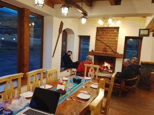 a group of people sitting around a table with a fireplace at Taytapak Wasi in Riobamba +24 photos