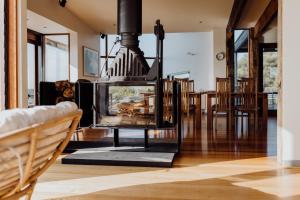a living room with a fireplace and a dining room table at Miramar Beach House in Seymour