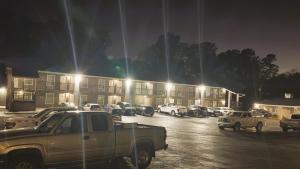 a white truck parked in a parking lot at night at Jackson Town House Inn in Jackson
