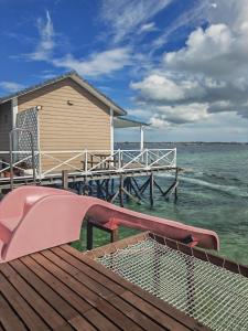 a house on a dock with a pink slide at 微拉瓦丽 in Semporna +14 photos