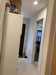 a room with a wall and a door with a ladder at Bessalov Home 1st room friendly house in Tokyo