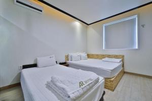 En eller flere senge i et værelse på Hotel ARA - Busan Haeundae