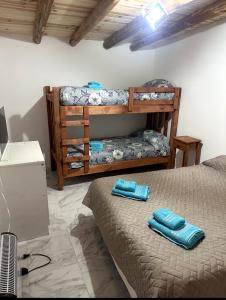a bedroom with two bunk beds with blue towels at Luxfran in Uspallata